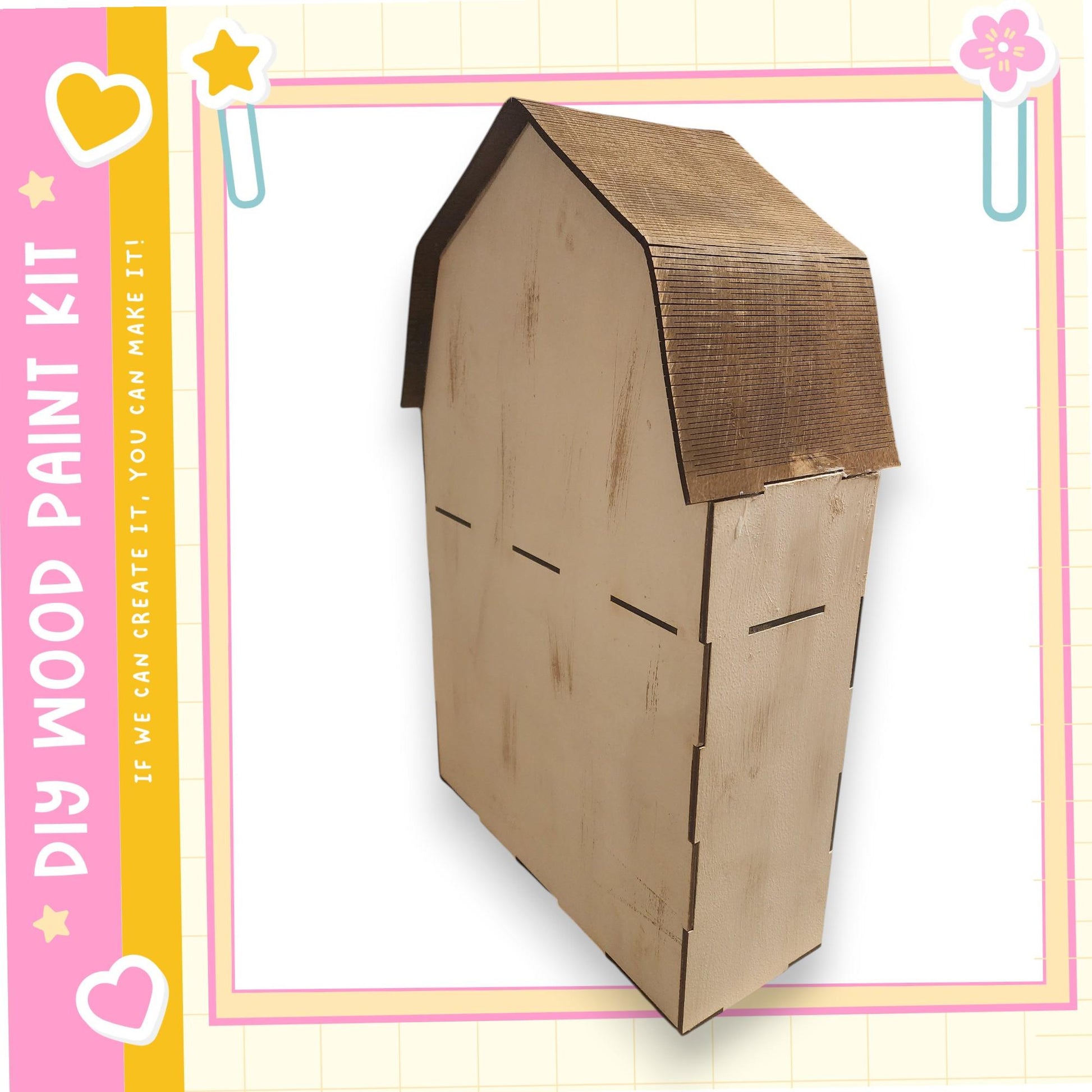 A wooden house kit with a brown roof and a heart-shaped cutout on the side, displayed against a pink and yellow background.