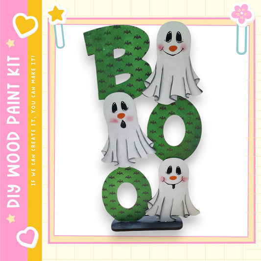 A wooden sign with the word "BOO" made up of three ghostly figures, each with a unique expression.