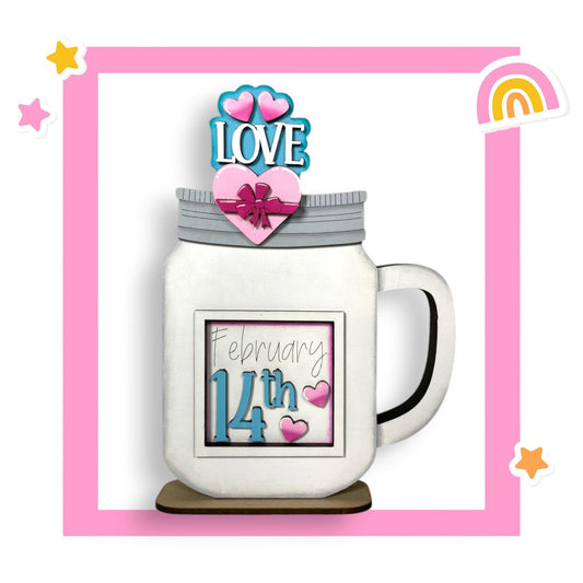 a white mug with a pink heart on top of it