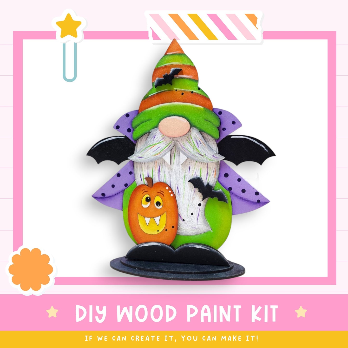 a DIY wood paint kit for creating a Halloween-themed decoration, including a gnome-like figure with a bat-like hat, a carved pumpkin, and a star.
