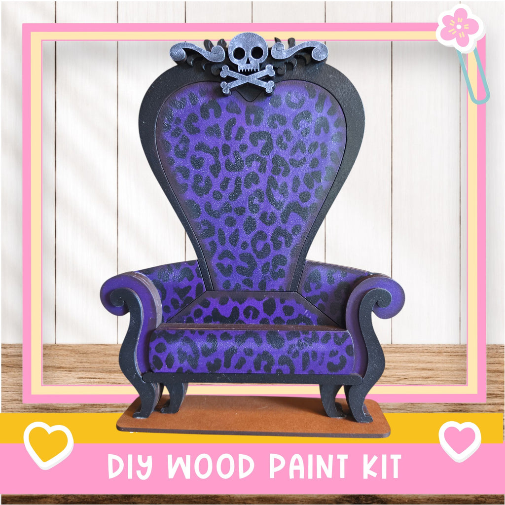 A purple and black leopard print chair with a skull and crossbones design, placed on a wooden surface.