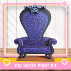 A purple and black leopard print chair with a skull and crossbones design, placed on a wooden surface.