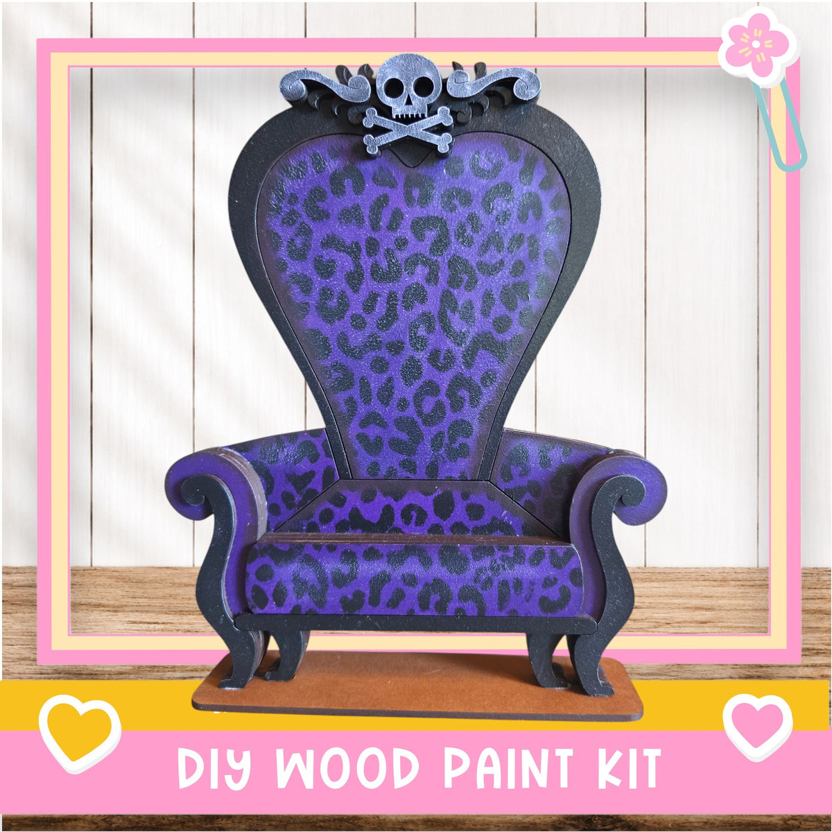A purple and black leopard print chair with a skull and crossbones design, placed on a wooden surface.