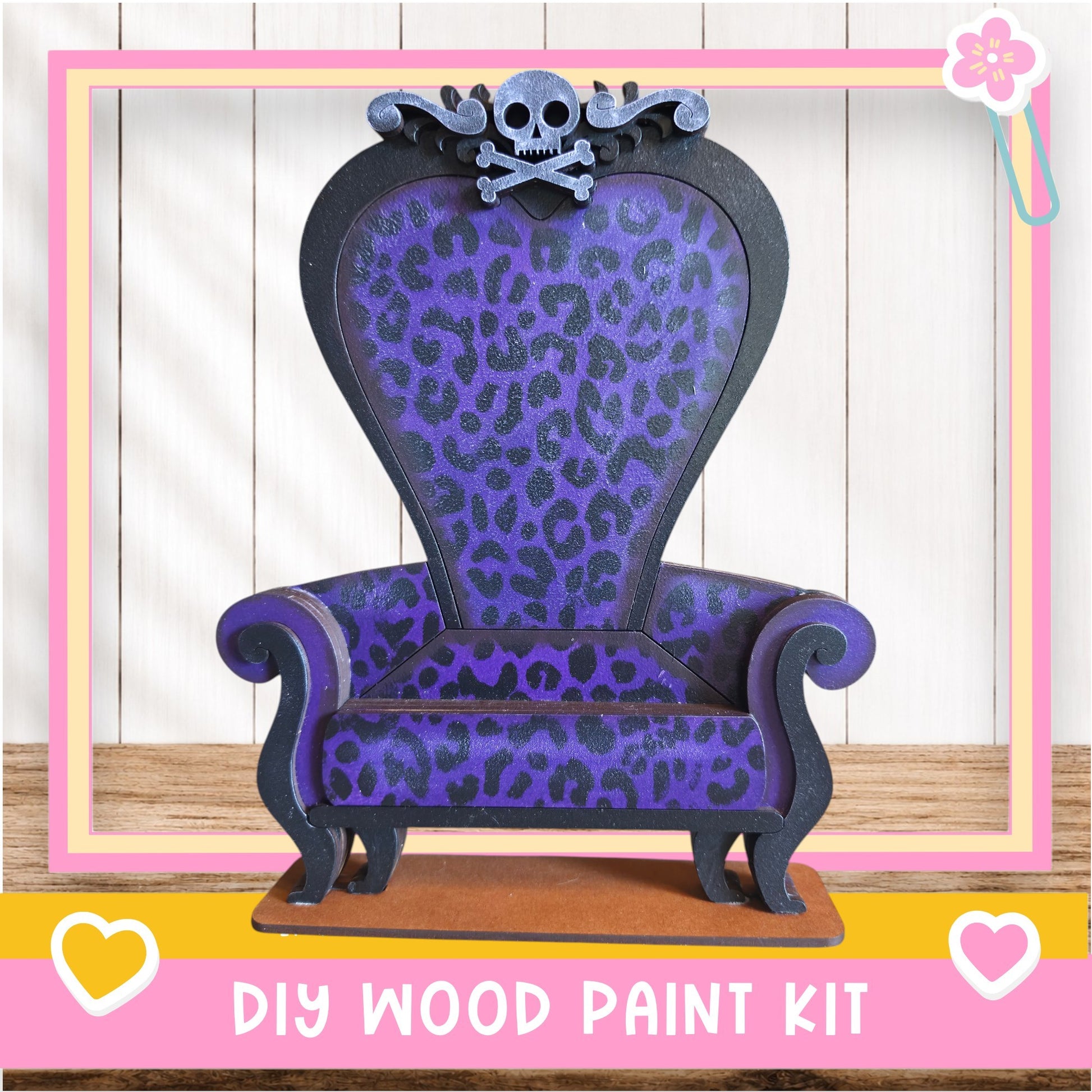 A purple and black leopard print chair with a skull and crossbones design, placed on a wooden surface.