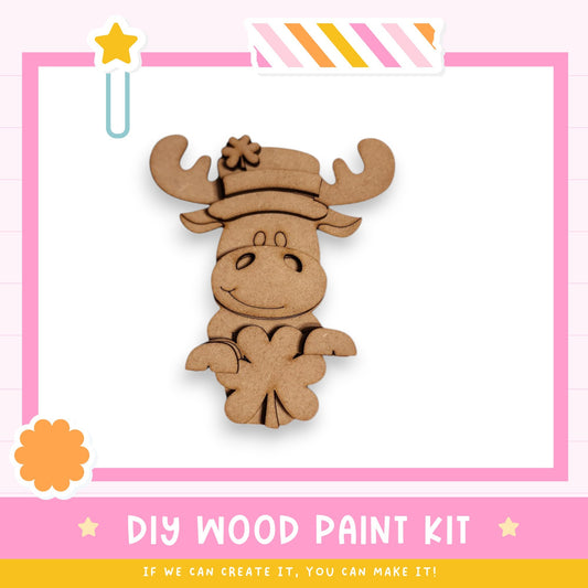 a DIY wood paint kit for creating a wooden character, such as a moose or a bear, with a hat and antlers. The kit includes a wooden figure and instructions for painting it.