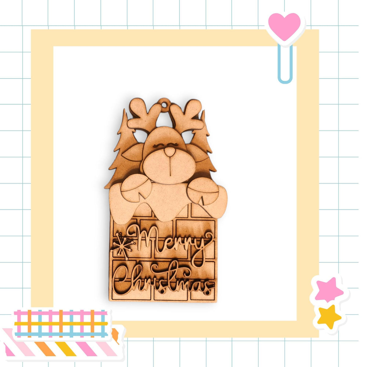 A wooden Christmas ornament with a reindeer and the text "Merry Christmas" is displayed against a grid background with various colorful stickers.
