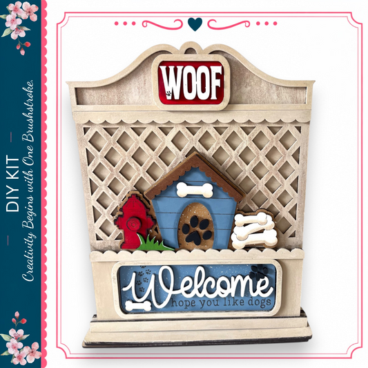a wooden dog house with a "WOOF" sign above it, and a "Welcome" sign below. The dog house has a red fire hydrant and a green plant on it. The sign above the dog house says "WOOF", and the sign below the dog house says "Welcome". The image also includes a decorative border with pink flowers.
