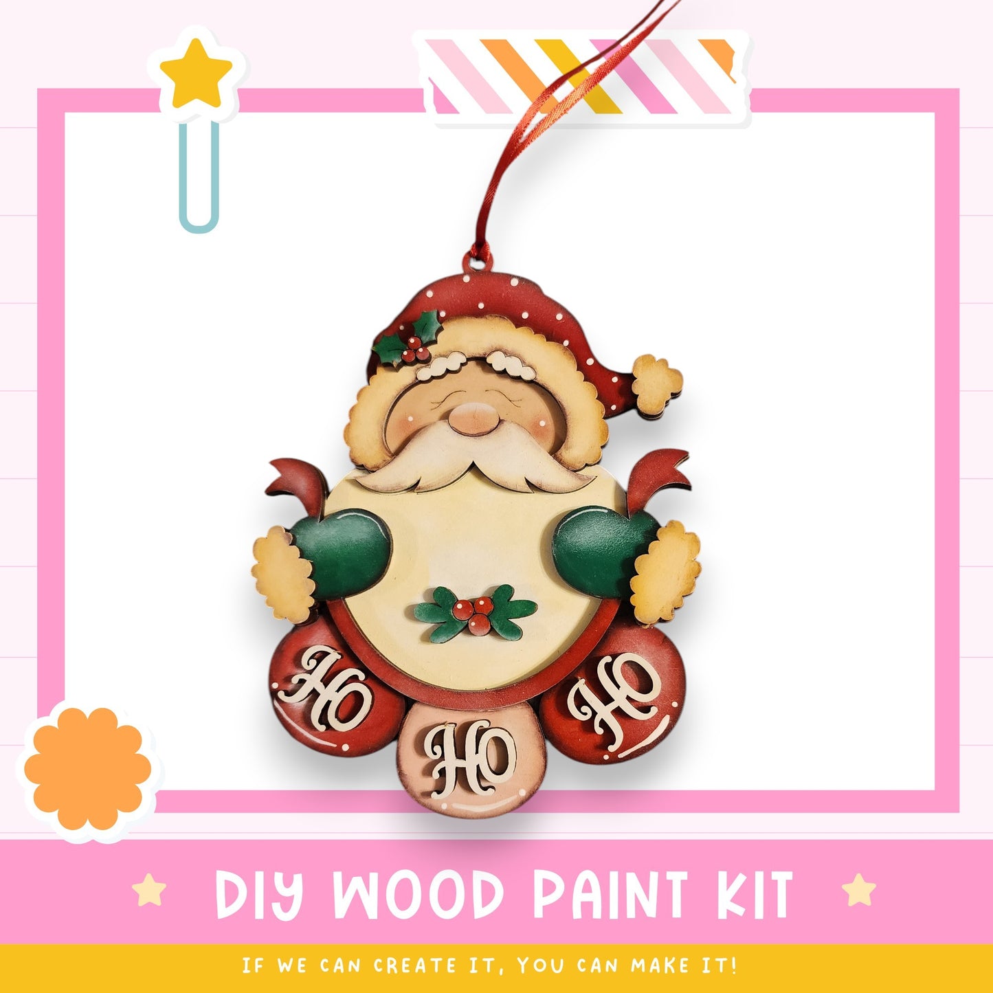 a DIY wood paint kit for creating a wooden ornament with a Santa Claus design. The kit includes a wooden Santa Claus figure, a red ribbon, and the words "Ho Ho" written on the ornament.
