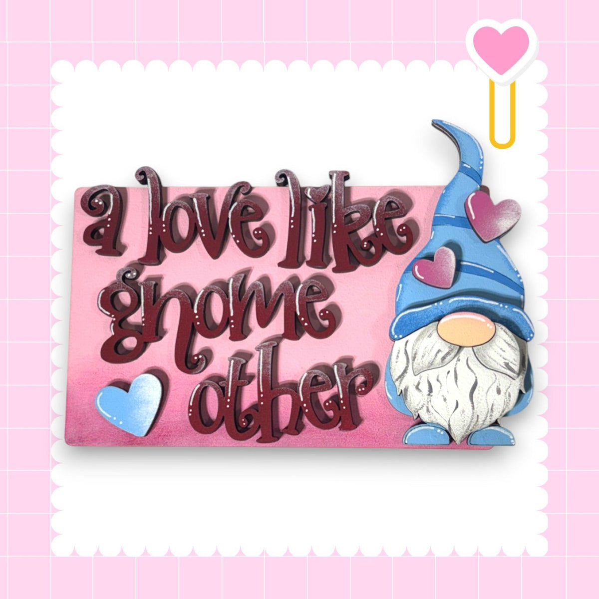 a pink plaque with a gnome and a heart on it