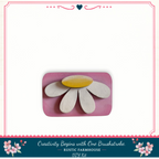 A DIY kit for creating a flower-like object, with a pink background and a decorative border.