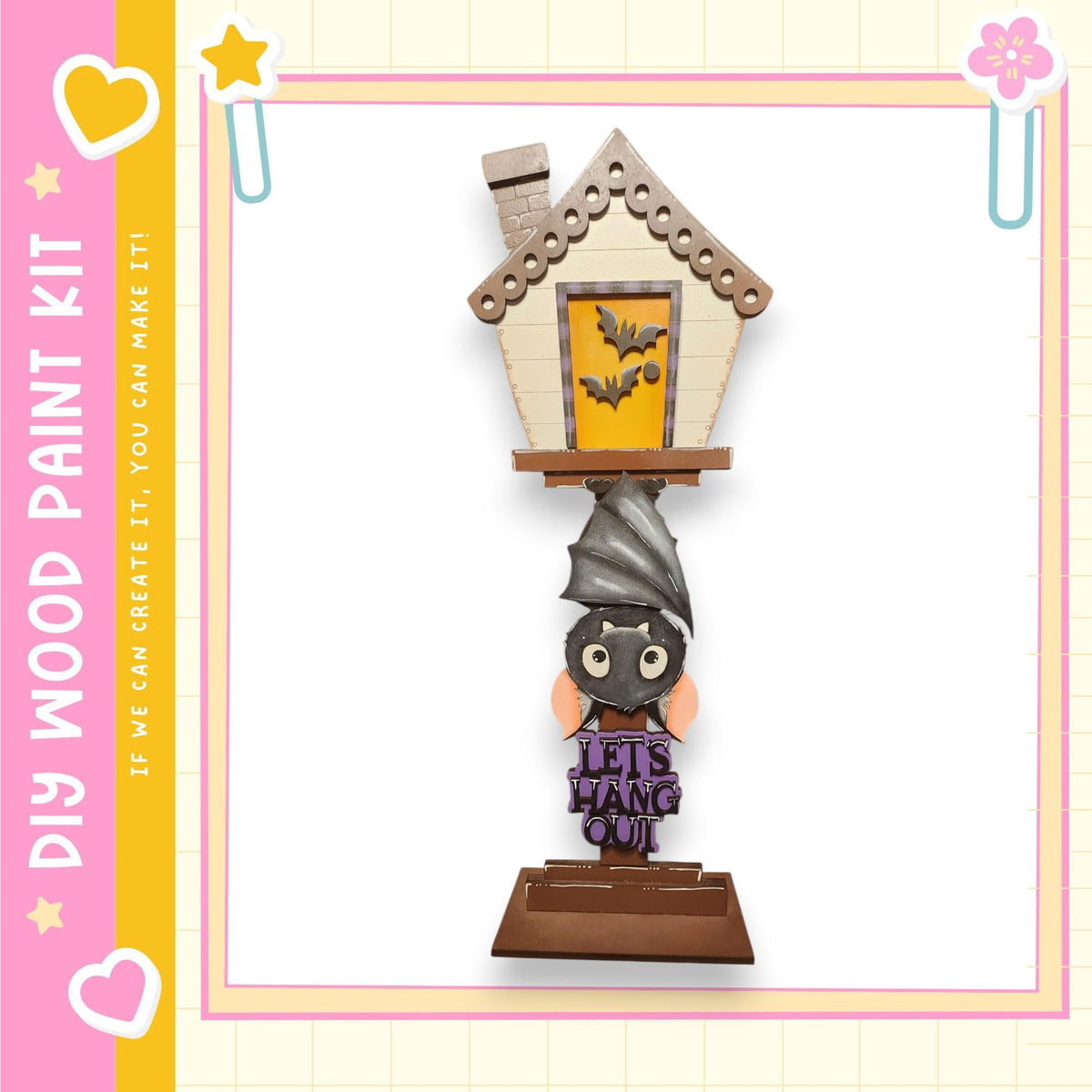 A Halloween-themed wooden paint kit featuring a bat-shaped house decoration with a sign that says "Let's hang out".