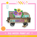 A wooden cart with a sign that says "A mother's love" and a vase of flowers, along with a star and a flower-shaped object.