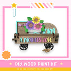 A wooden cart with a sign that says "A mother's love" and a vase of flowers, along with a star and a flower-shaped object.