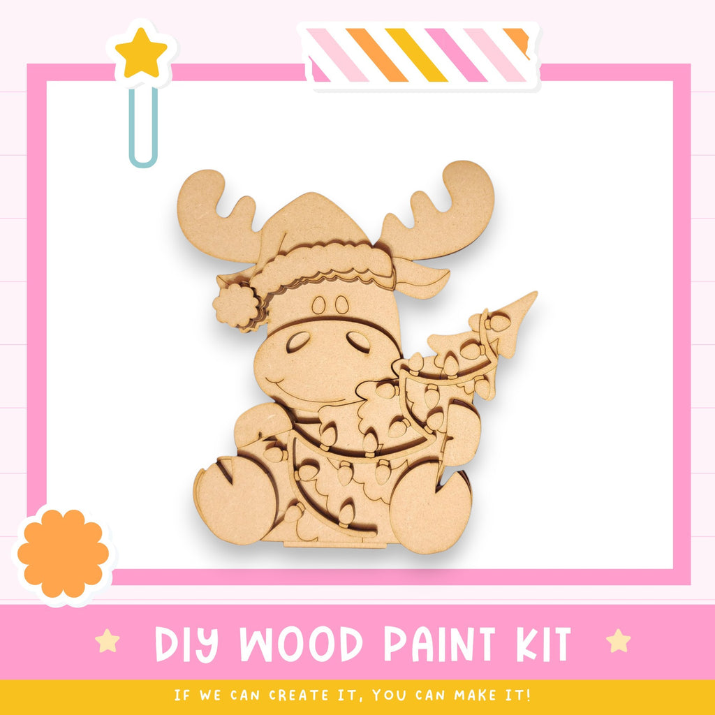 a wooden cutout of a moose with a santa hat
