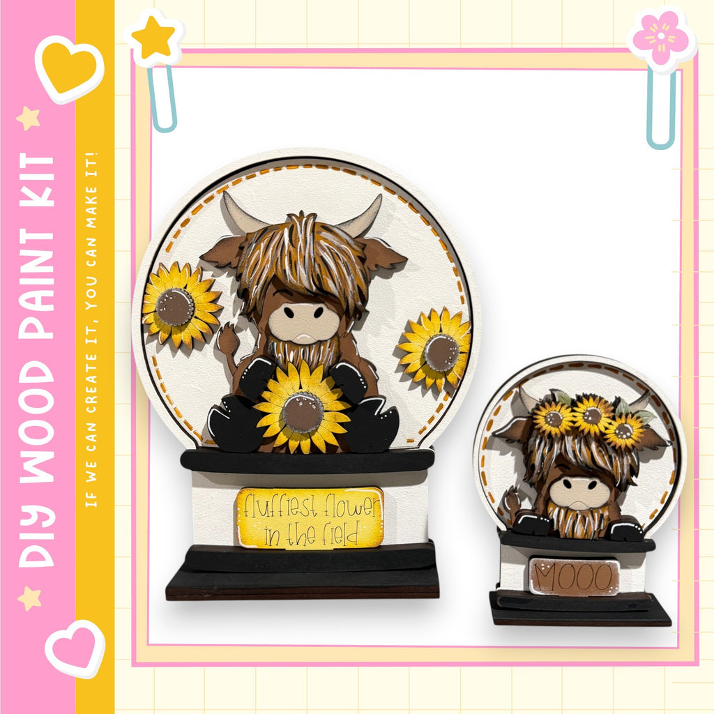 a wooden paint kit with a design of a cow and sunflowers. The kit includes a wooden base and a wooden frame, and it is described as a kit for creating wooden paint pieces.