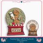 two gingerbread man figurines, one larger and one smaller, both holding candy canes and surrounded by a red and green snow globe. The larger snow globe has the word "Cookies" written on it, and the smaller one has the phrase "Santa's Cookie Crew" written on it. The snow globes are set against a white background, and there is a decorative border around the image.