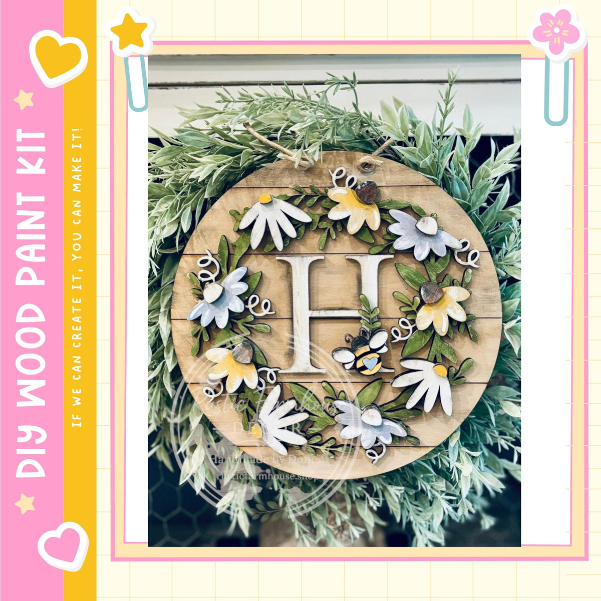 A decorative wreath made of wood and adorned with various flowers and leaves, including a large letter "H" in the center.