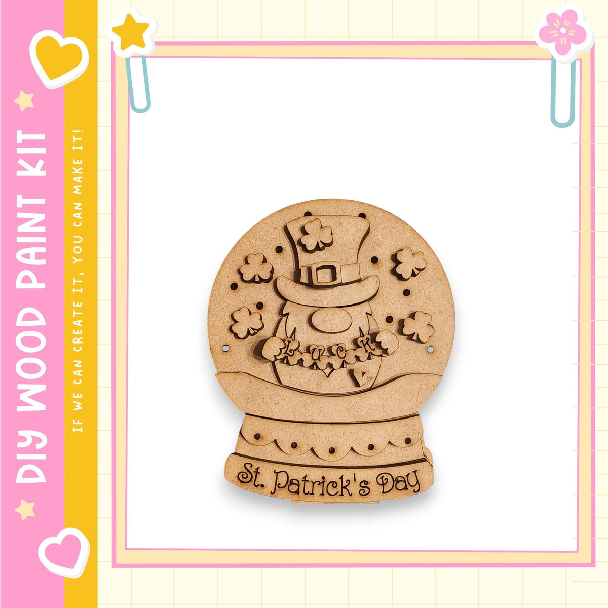 A wooden snow globe with a clover design, surrounded by a decorative border, is displayed against a pink and yellow background.