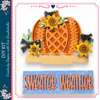 The image is a collage featuring a pumpkin with sunflowers and birds, along with the text "Sweater Weather" and "DIY KIT" in the corners.