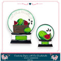 two decorative items with a watermelon theme. The larger item is a decorative plate with a watermelon design and the word "FRESH WATERMELON" written on it. The smaller item is a decorative bowl with a watermelon design and the word "SUMMER" written on it. Both items are placed on a white background, and the image includes text that reads "Creativity Begins with One Brushstroke - RUSTIC FARMHOUSE - DIY KIT".