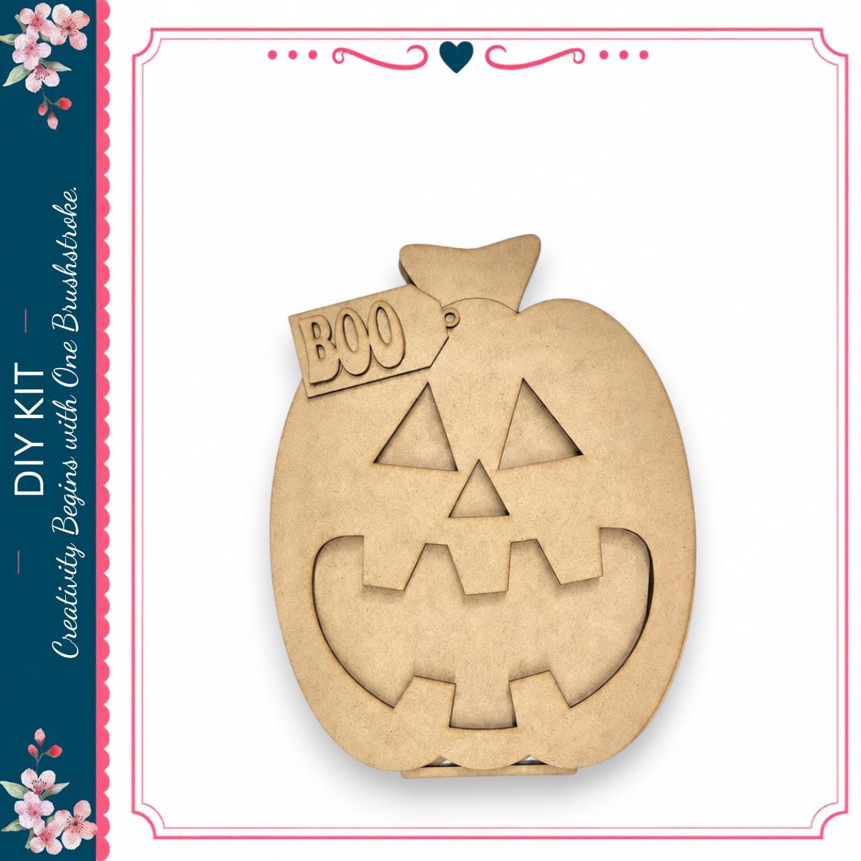 A wooden pumpkin with a carved face and the word "BOO" on it, displayed against a white background.