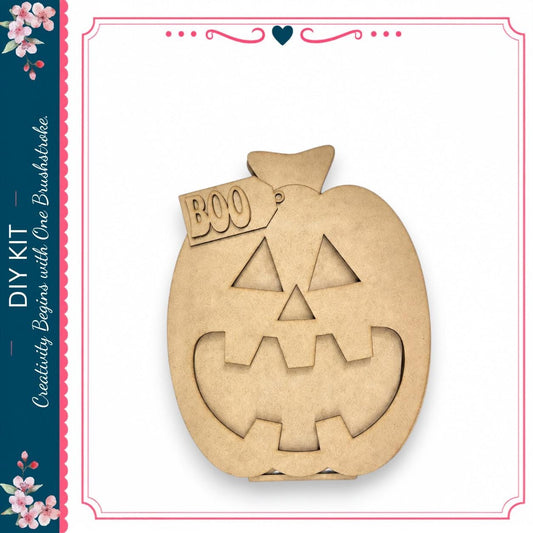 A wooden pumpkin with a carved face and the word "BOO" on it, displayed against a white background.