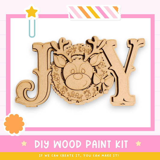 a DIY wood paint kit for creating a wooden sign or decoration with the word "Joy". The kit includes a wooden deer head and a wreath, which can be used to create a festive and decorative piece.