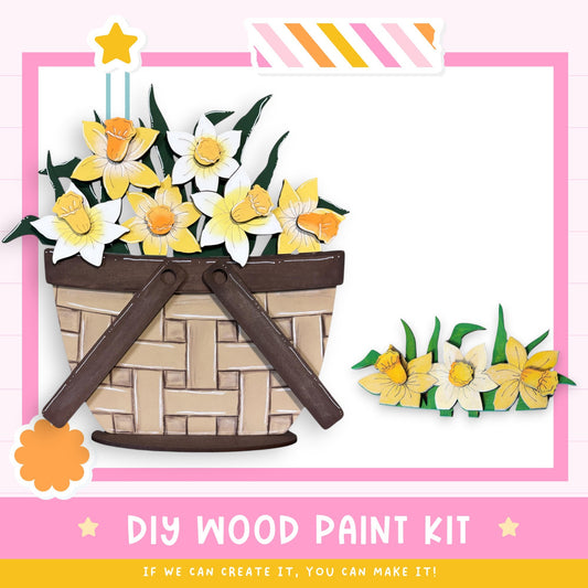 a DIY wood paint kit, with a basket of yellow and white flowers and a small flower arrangement on a pink background. The kit appears to be made of wood and is designed for creating wooden paint projects.
