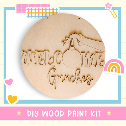 a DIY wood paint kit for creating a welcome sign with the word "Grinchies" carved into it.