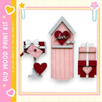 a pink wooden mailbox with a heart-shaped sign that says "love" on it, along with two smaller wooden boxes decorated with hearts.