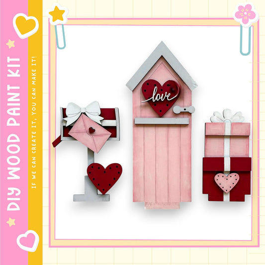 a pink wooden mailbox with a heart-shaped sign that says "love" on it, along with two smaller wooden boxes decorated with hearts.