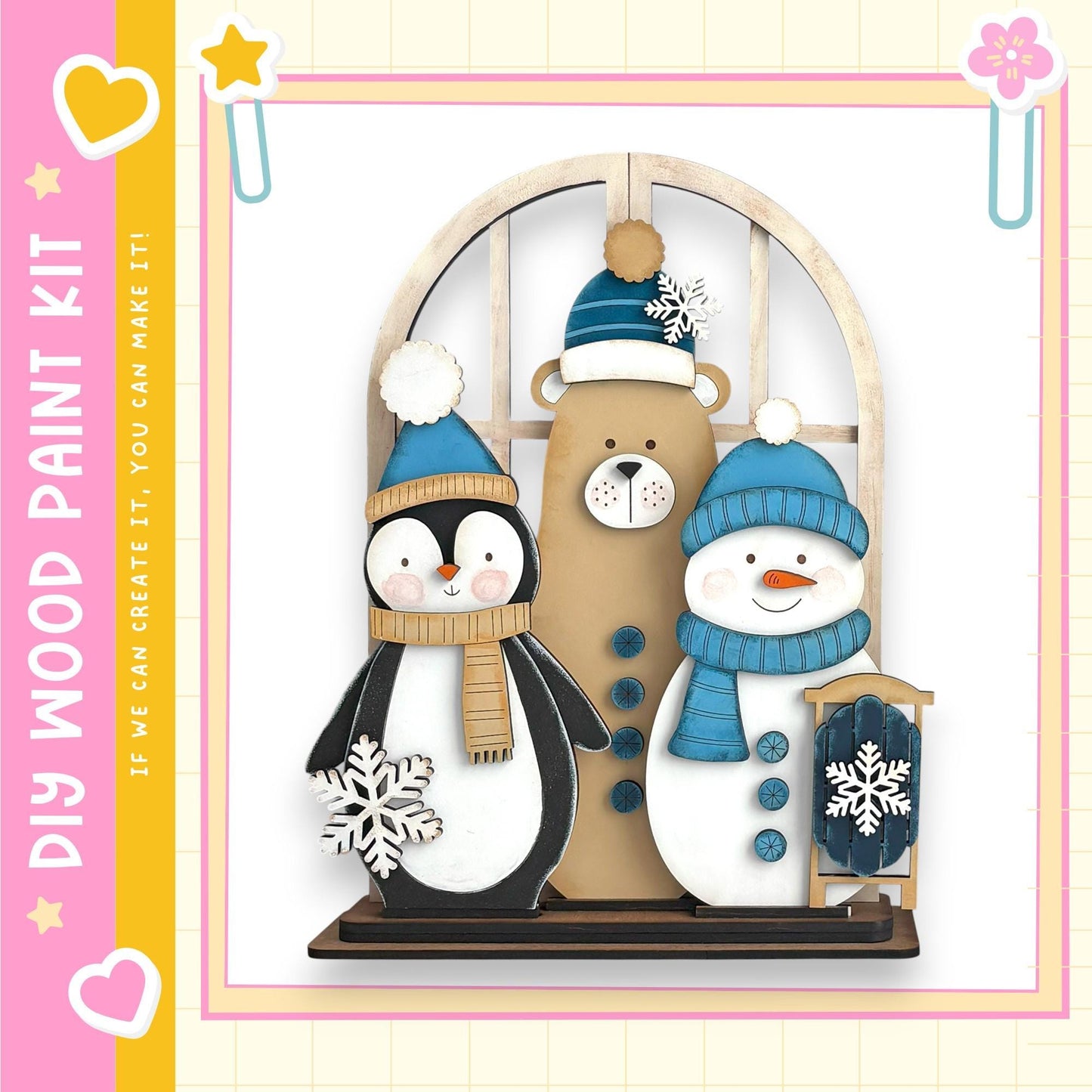 A wooden paint kit depicting a penguin, a bear, and a snowman, all wearing winter hats and scarves.
