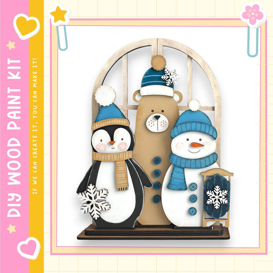 A wooden paint kit depicting a penguin, a bear, and a snowman, all wearing winter hats and scarves.