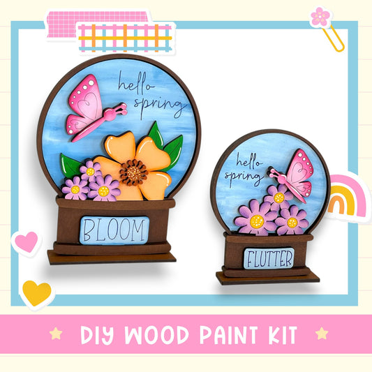 two wooden paint kits labeled "Bloom" and "Flutter" that are designed to create spring-themed decorations.
