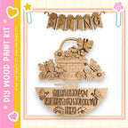 a wooden sign with the word "SPRING" written on it, along with various decorative elements such as butterflies and flowers. The sign appears to be a part of a larger wooden craft kit, as indicated by the text "My Wood Paint Kit" and "If we can create it, you can make it".
