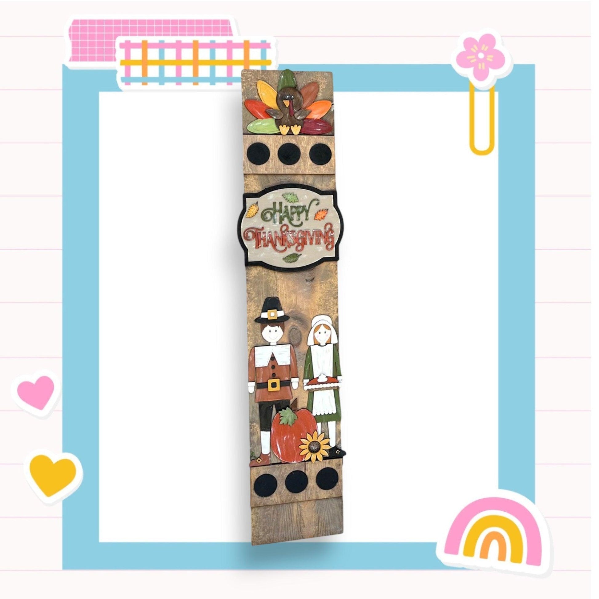 a picture of a tall wooden tower with a happy thanksgiving sign on it