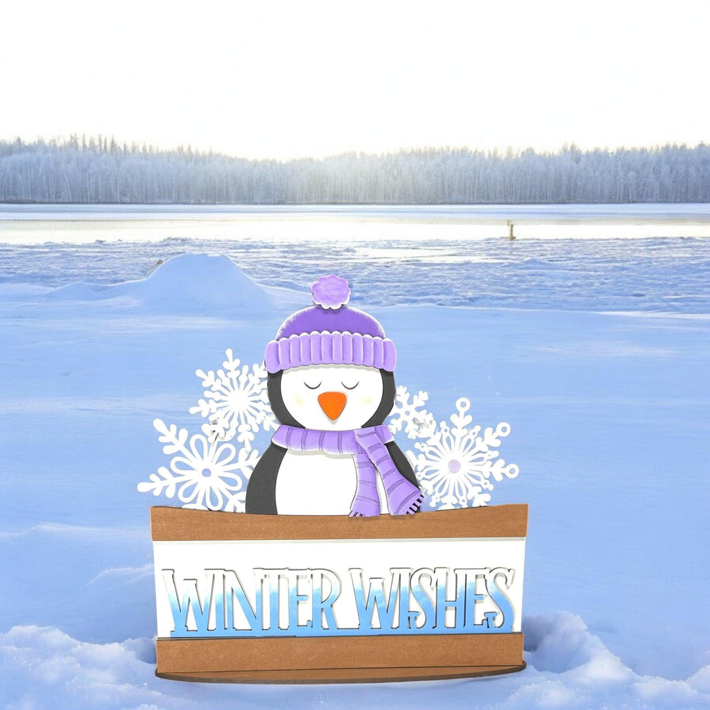 a cardboard box with a snowman in it in the snow