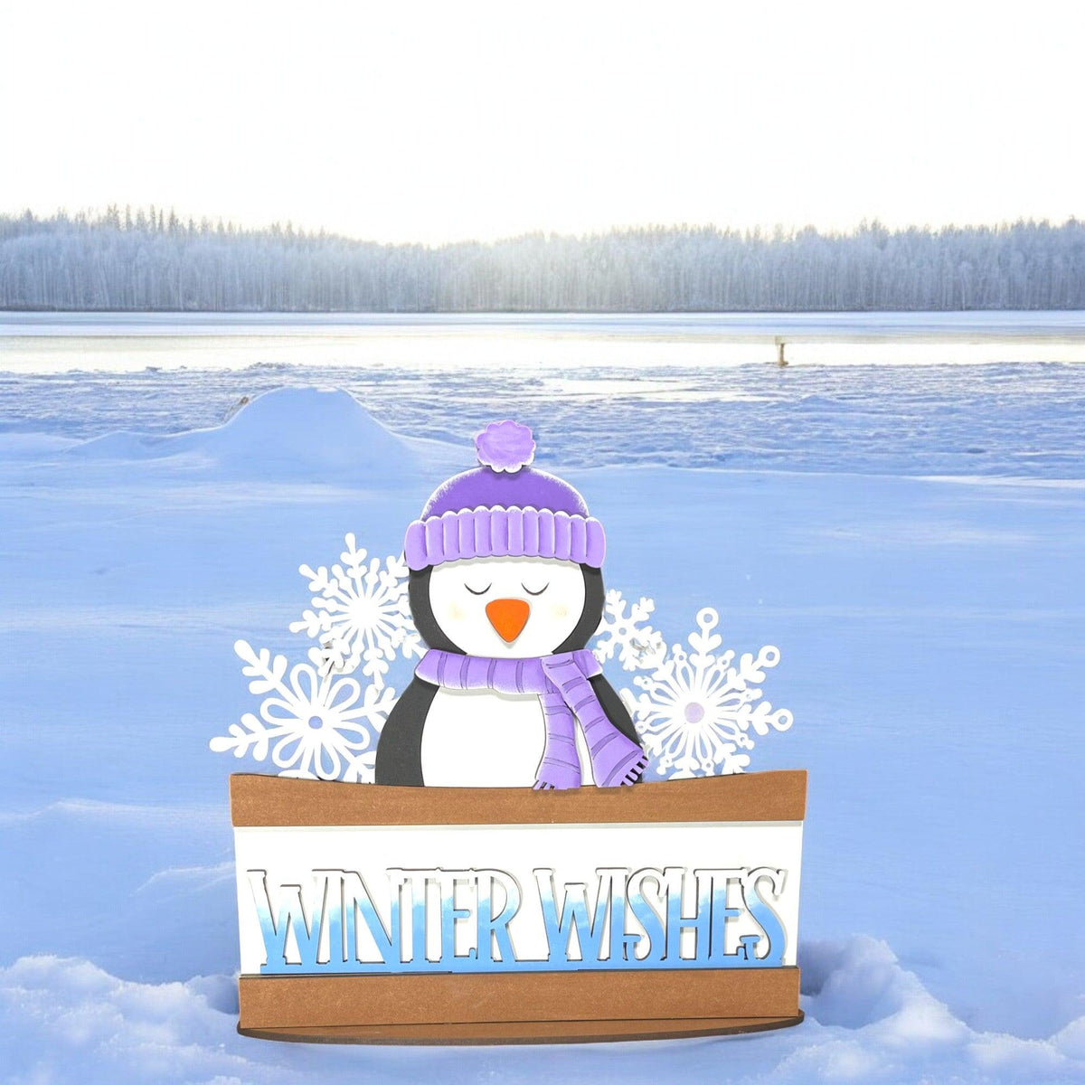 a cardboard box with a snowman in it in the snow