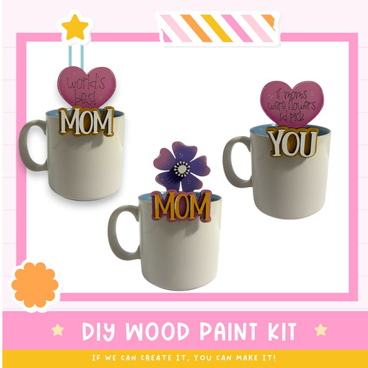 three mugs with personalized messages, including a heart-shaped sticker that says "WORLD'S BEST MOM" and two stickers that say "IF MOMS WERE FLOWERS I PICK YOU". The mugs are displayed against a pink background, and there is text at the bottom of the image that reads "DIY WOOD PAINT KIT" and "IF WE CAN CREATE IT, YOU CAN MAKE IT!".
