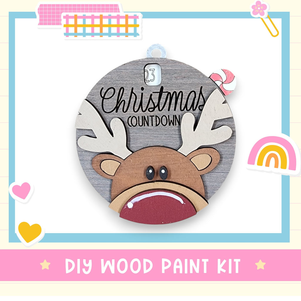 a wooden christmas ornament with a reindeer's face