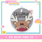 a wooden christmas ornament with a reindeer's face
