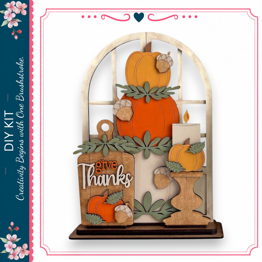 The image is a decorative piece featuring a wooden frame with a window, displaying a collection of autumn-themed items such as pumpkins, leaves, and a candle.