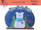 A decorative snow globe featuring a white polar bear surrounded by snowflakes and trees, with the text "Warm Winter Wishes" written above it.