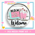 a wooden sign with a cupcake and a sign that says, mom you '