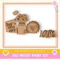 a DIY wood paint kit with various wooden shapes and designs, including a heart-shaped piece and a flower-shaped piece, all set against a pink and yellow background.