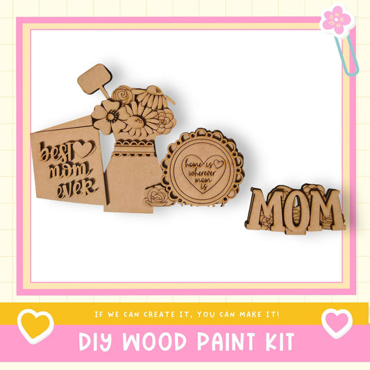 a DIY wood paint kit with various wooden shapes and designs, including a heart-shaped piece and a flower-shaped piece, all set against a pink and yellow background.
