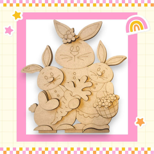 a wooden cutout of two rabbits holding a basket of flowers