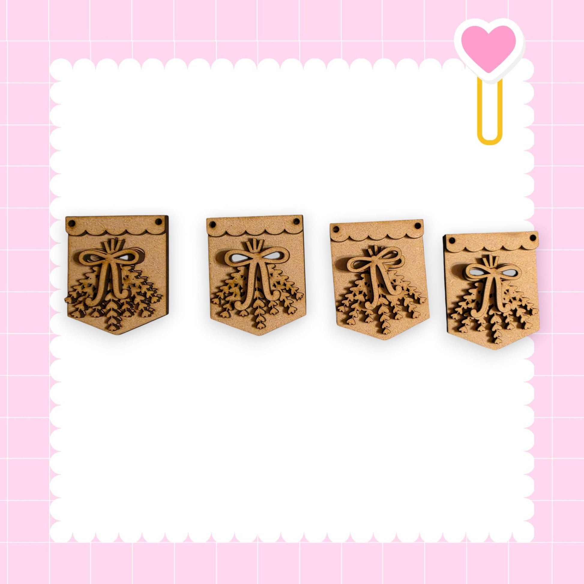 four wooden pendants with decorative bows, arranged in a row against a pink background with a scalloped edge.