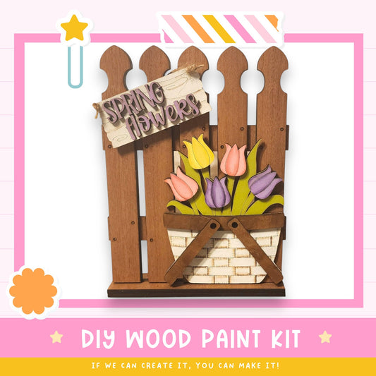 a DIY wood paint kit for creating a wooden fence with a basket of colorful tulips.