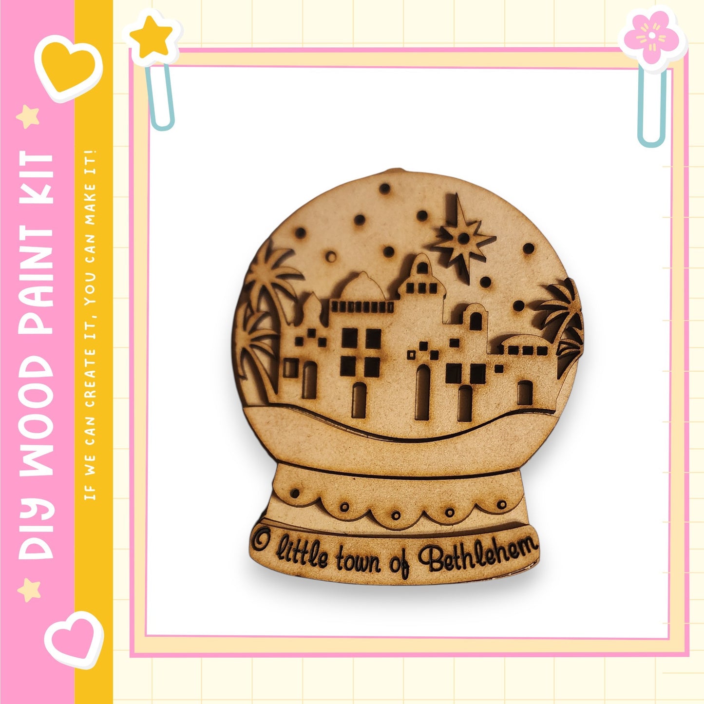 A wooden snow globe with a design depicting a small town, surrounded by palm trees and stars.